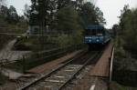 Blue train on a bridge