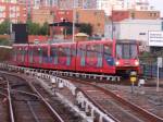A pair of DLR units arriving at Poplar.