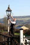 Porter at Oakworth winding the gas lamp clock up. 16.02.2008